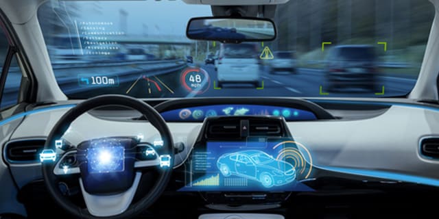 Driver monitoring system view from the inside of a sedan.
