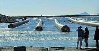 Distributed Bouyancy Modules, powered by 3M Glass Bubbles are photographed from the shore.