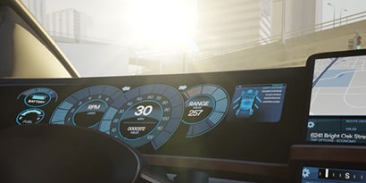 Bright sun shining through the windshield of a car. Driver information display showing.
