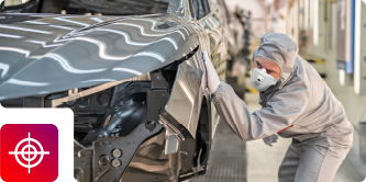 An automotive worker in protective gear inspects a gray vehicle body, featuring a target precision icon

