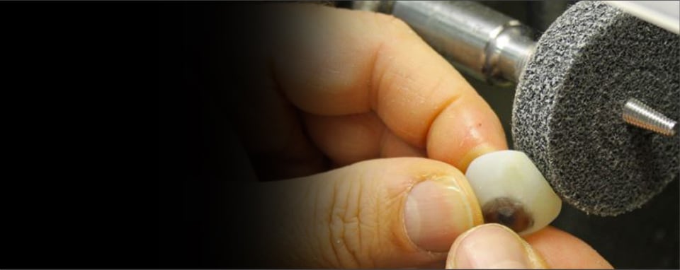 Image of worker grinding artificial eyeball.