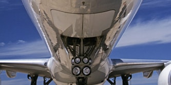 Upshot of the bottom of a plane and its landing gear.