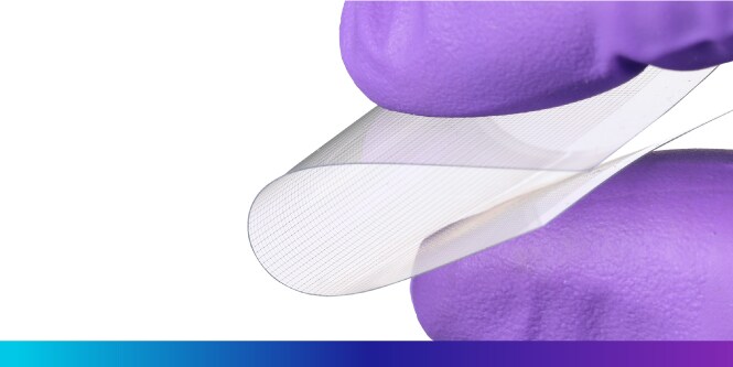 Hyper close-up of two fingers bending a transparent conductive film.
