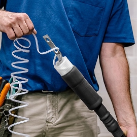 worker unwinding 3M cold shrink splice over termination