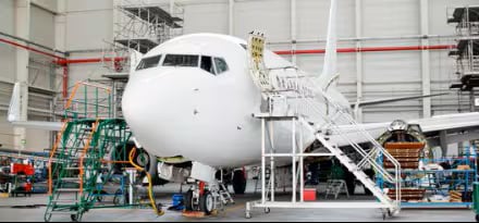 crew performing maintenance and repair on an aircraft
