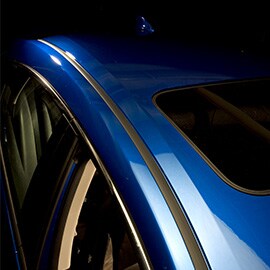 Close-up of the bond lines on the passenger side of a blue vehicle.