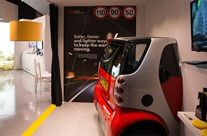 A smart car sticking out of the wall at one of our Customer Innovation Centers.