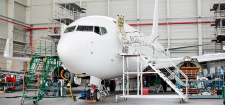 crew performing maintenance and repair on an aircraft
