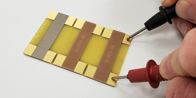 Someone testing the electrical resistance on various materials. 
