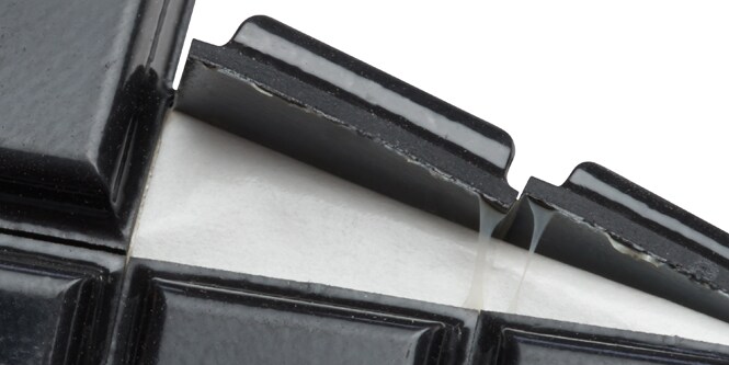 Close‑up of 3M adhesive on a sheet of rubber Bumpons.
