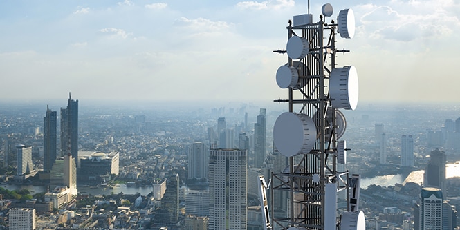 A large antenna installment against a city skyline.
