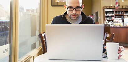 Person working on laptop in public
