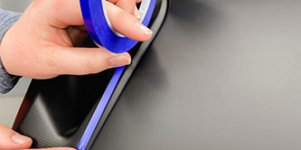 Person using a roll of 3M Masking Paper for Transportation.
