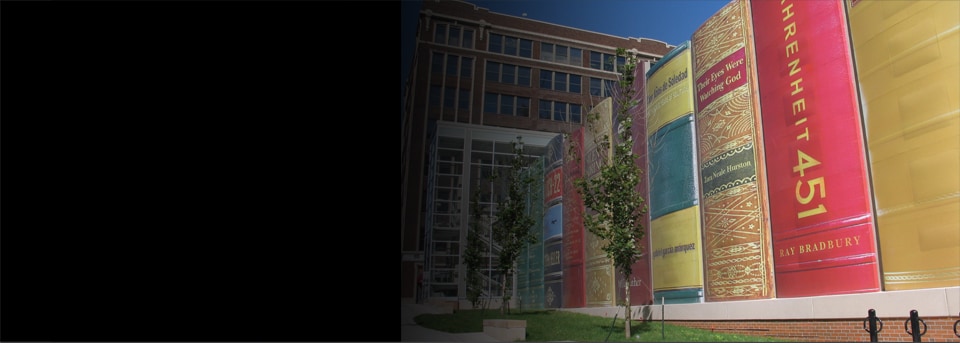 Looking up from the sidewalk, a view of the Kansas City Central Library car park. Wrapped in 3M Controltac Graphic Film, this car park appears to be a line of giant books.