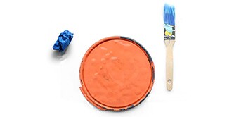 Image showing a paint lid with orange paint, masking tape and a paint brush
