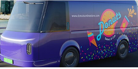 Purple delivery van wrapped in colorful 3M graphics for a donut bakery brand.
