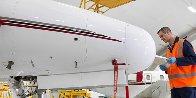 Person inspecting an aircraft radome.
