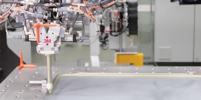 Video thumbnail showing the application of 3M adhesive via robotic arm.
