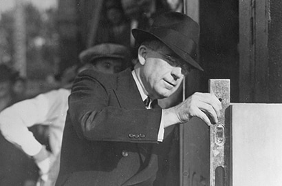 Former 3M Chairman of the Board William McKnight checking a building&rsquo;s cornerstone.