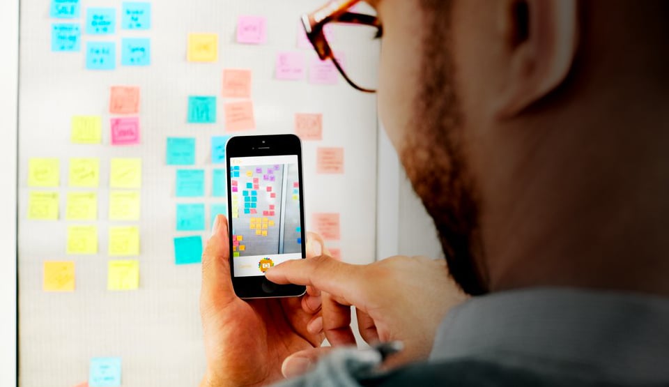 Customer using the Post-It Plus App on their cellphone, demonstrating taking a photograph of a Post-It Note brainstorming session.
