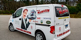 Delivery van displaying spot graphics and branded decals.
