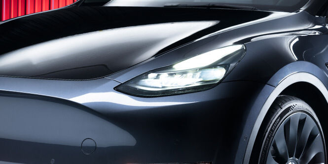 Person applying paint protection film to a car
