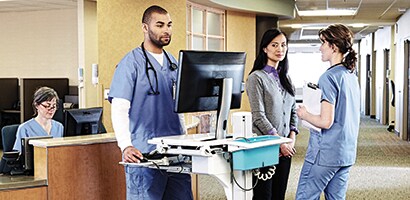 Visual hacker peeking at a monitor in a healthcare environment
