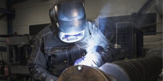 Men welding metal using a G5-01 Welding Helmet
